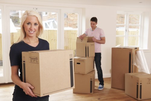 Professional movers carrying household items during a Cranham move