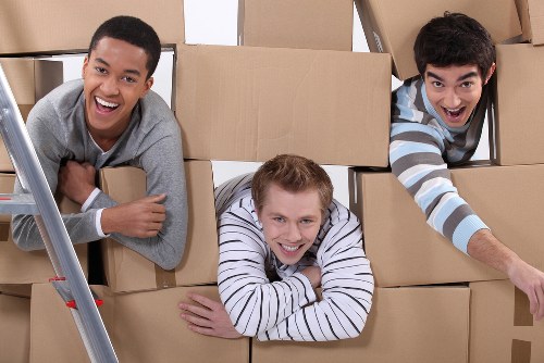 Professional packing service arranging boxes in Cranham home